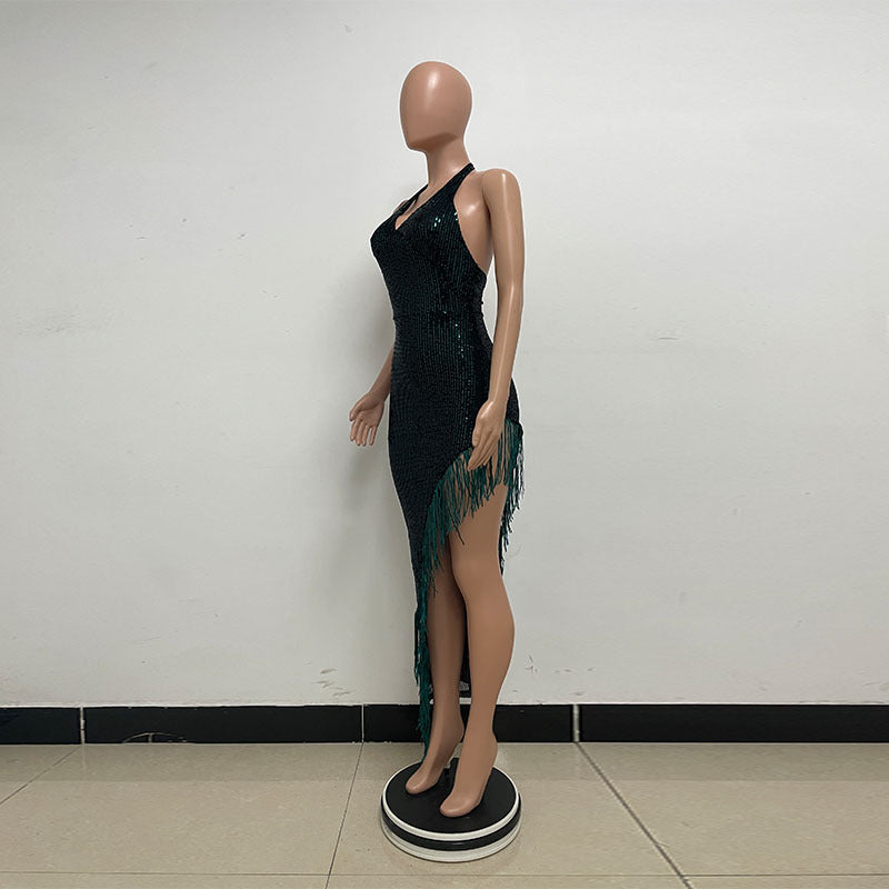 Dark green sequin dress on a mannequin with green fringe/tassel trim on the side.